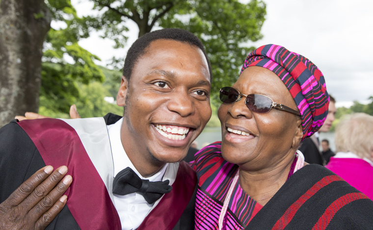 A graduate smiling on graduation day