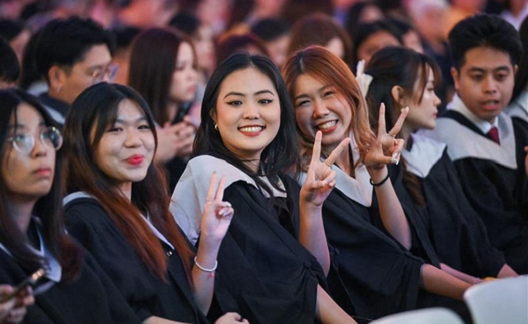 Students celebrating at the Singapore Institute of Management graduation