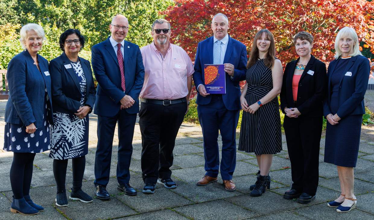 men and women standing outside in a line