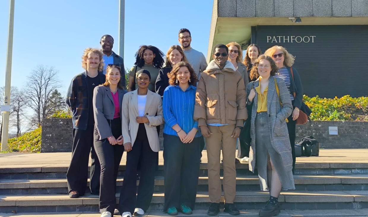 men and women standing outside