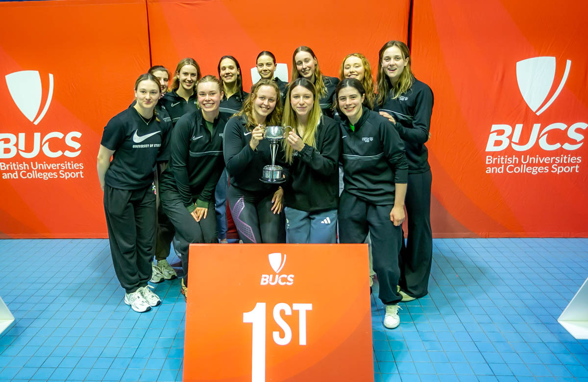 student athletes holding trophy