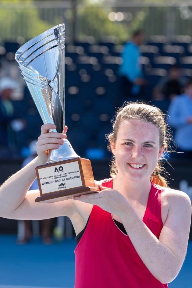 Anna McBride holds trophy aloft after winning her third title at the Australian Open.