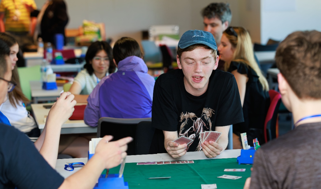young adult playing cards