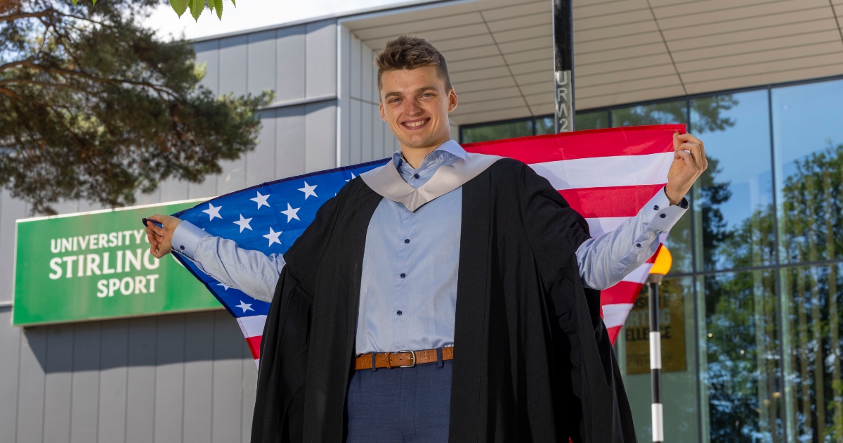 Tristen Bell poses outside the Sports Centre with the American flag.