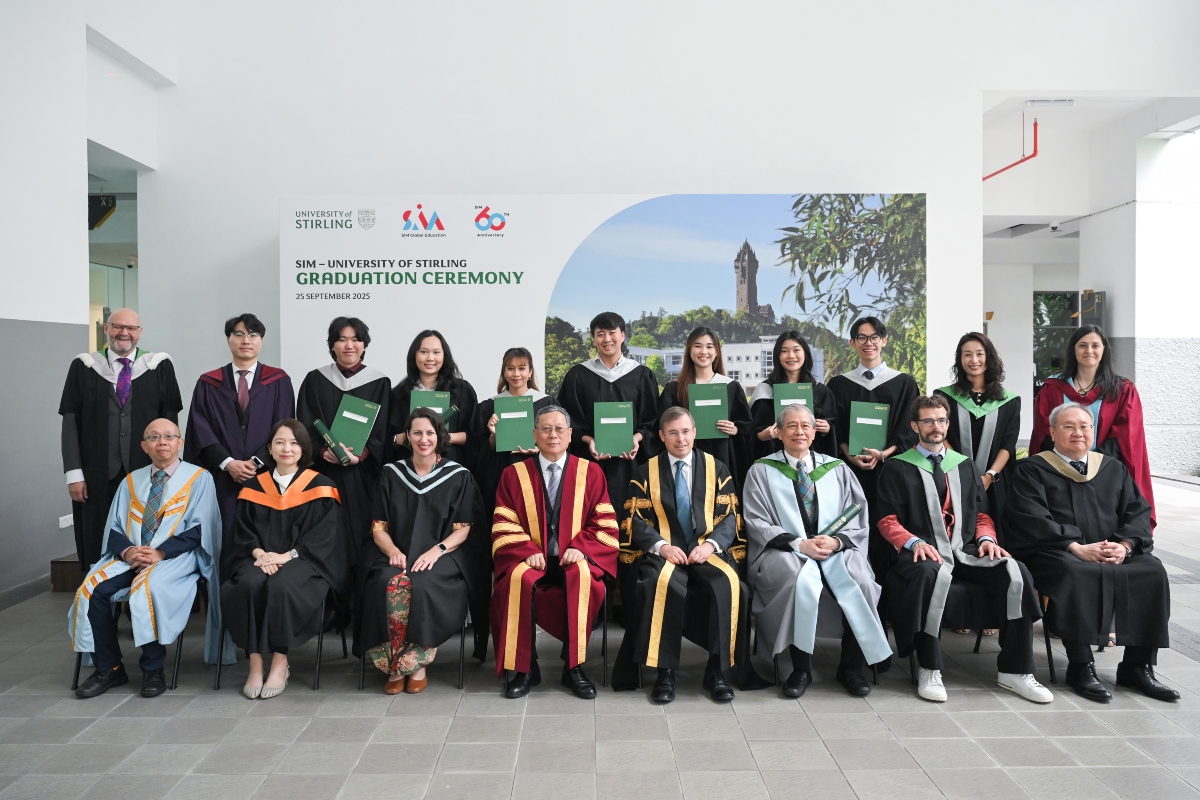 group of students and staff in graduation wear