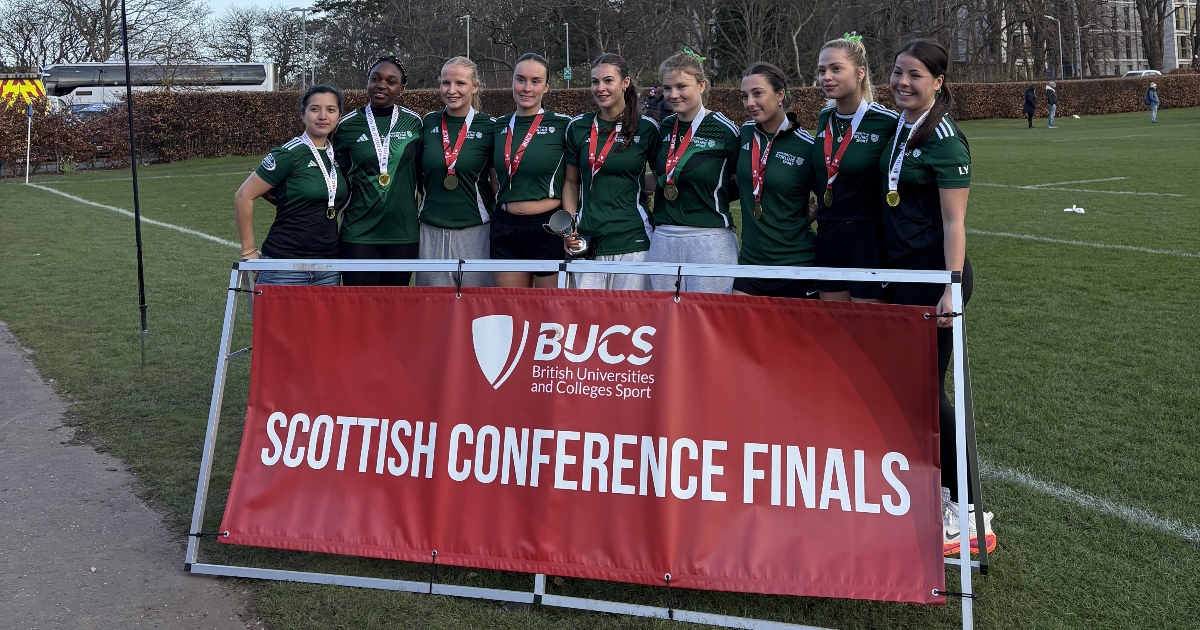 Tennis players celebrate win.