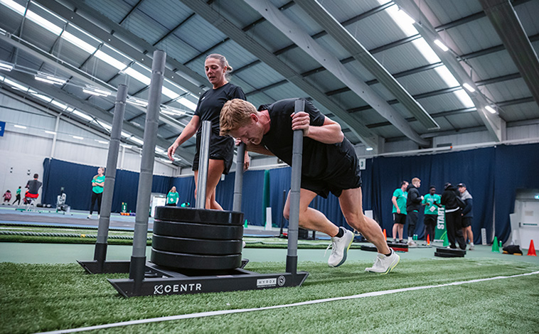 Man pushing weighted sled